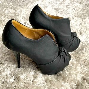 Black slip on bootie type stilettos.